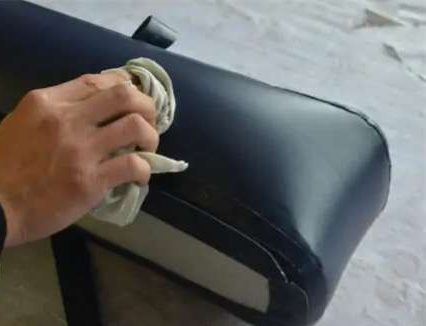 Cleaning inflatable PVC surface with isopropyl alcohol before repair