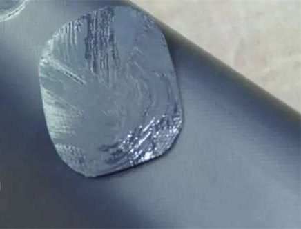 Placing PVC repair patch over damage