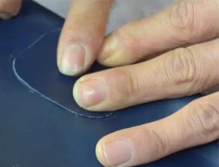 Pressing patch with seam roller to remove air bubbles