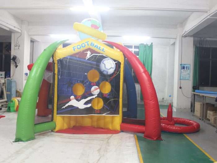 Inflatable football kick game booth with net-style target panel and five scoring holes valued 10 to 40 points